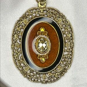 Vintage 1928 Pink Beaded Necklace with Gold Medallion with clear center stone.